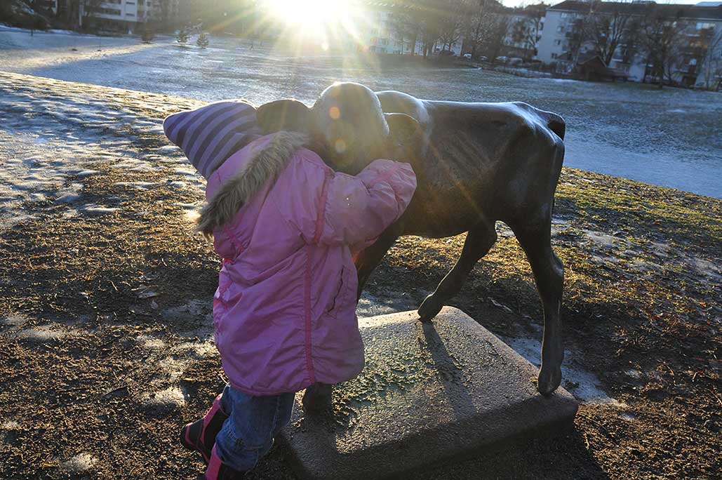 Leah hugging the cow statue.